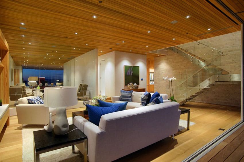 Contemporary living room design with retracting doors to patio and wood plank ceiling