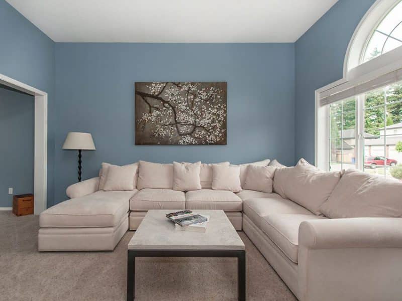 Living Room With Blue Walls And Brown Furniture