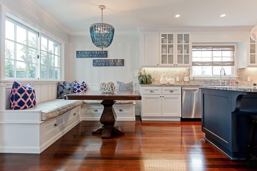 Kitchen with marine blue island, granite countertops and window seat bench