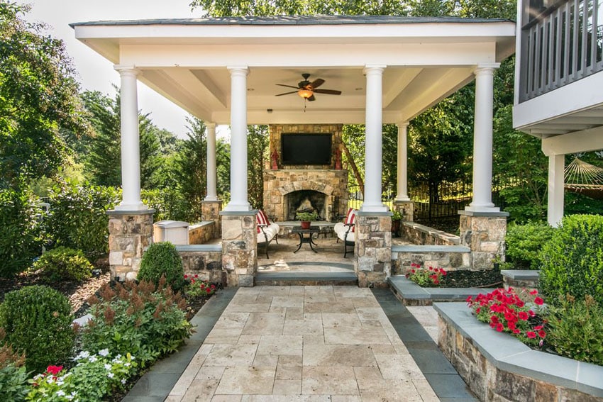 Patio with cabana, fireplace, tv and seating in garden