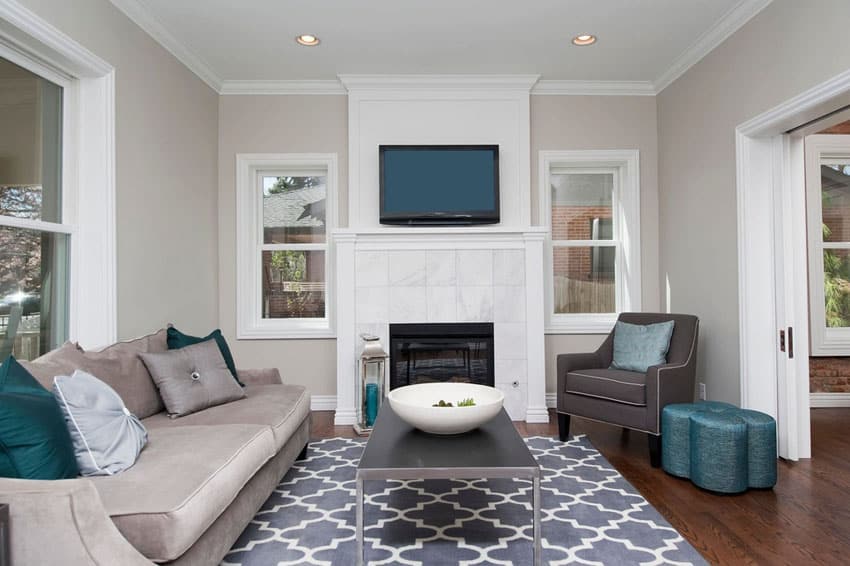 Cozy room with carrara marble fireplace and wood plank floors