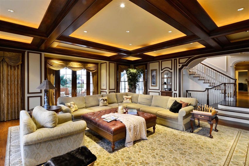 Room with backlit ceiling, wood molding and large area rug