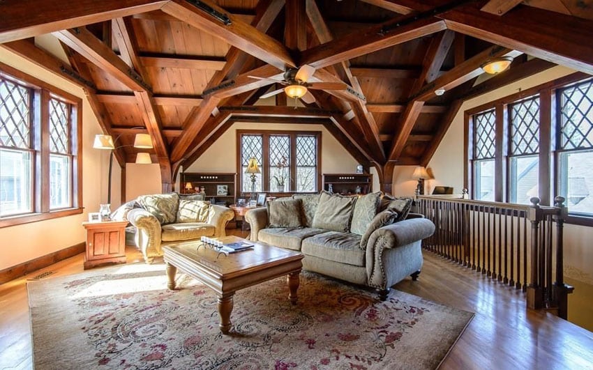 Craftsman living room with detailed open beam cathedral ceiling, wood lattice framed windows and wood flooring