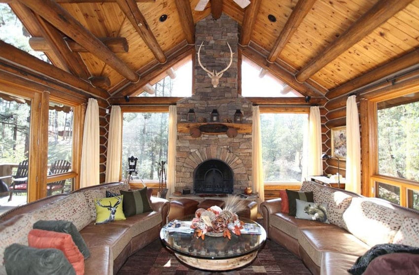 Craftsman living room with large picture windows and stone fireplace