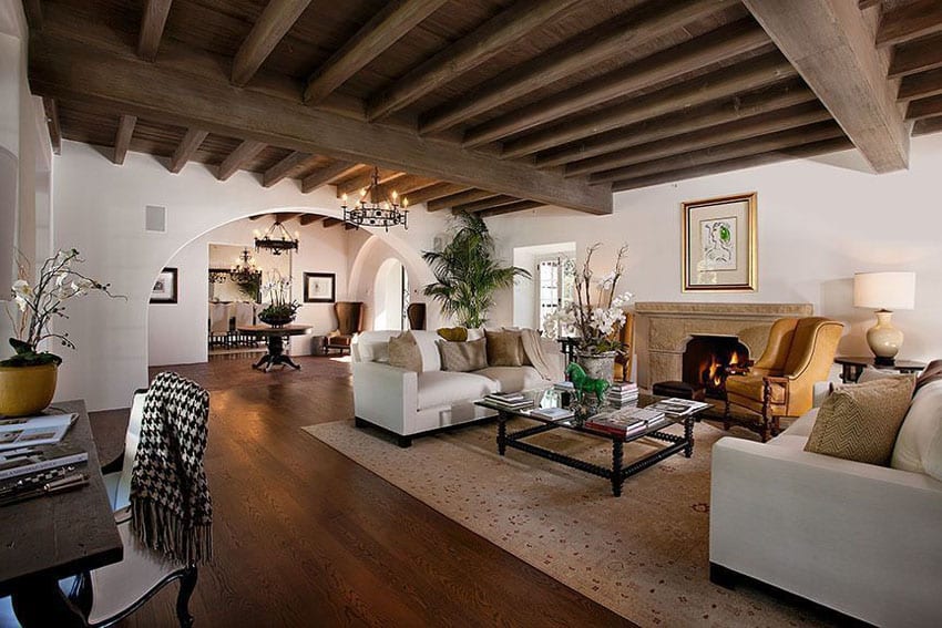 Room with white walls large arched doorway and beam feature ceiling