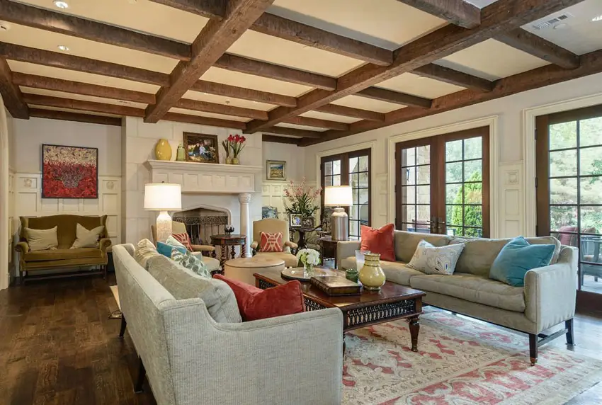 Room with rough exposed beams and dark stain flooring