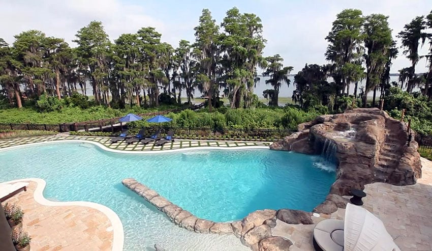Custom beach lagoon style pool with water feature slide