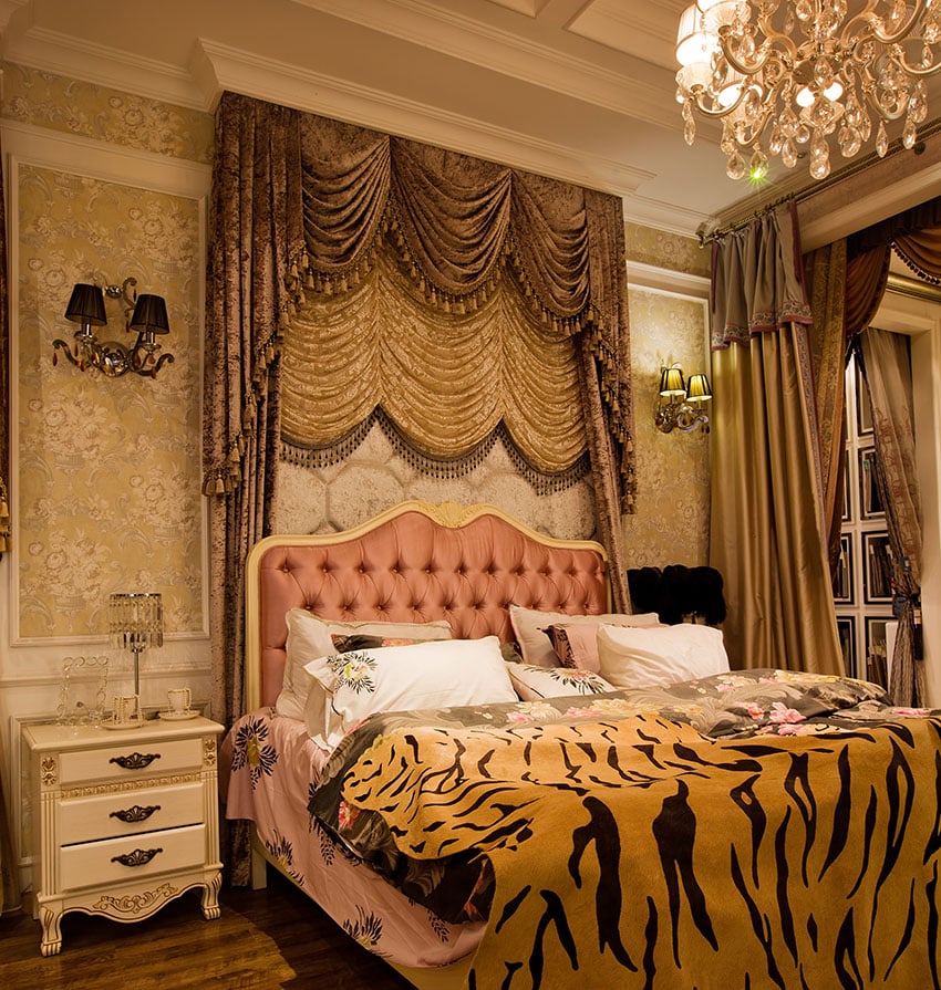 Custom designed bedroom with exotic furnishings such as bed drapery, tiger throw, and chandelier