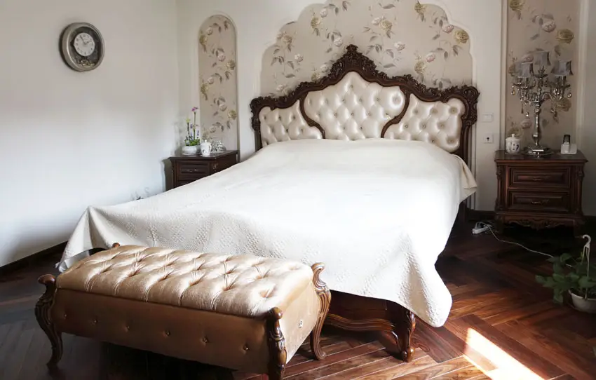 Custom designed bedroom with tufted bed and floral wall decor