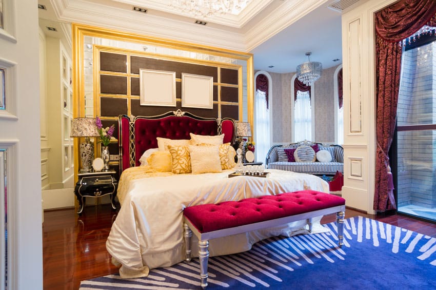 bedroom with bright color decor, bed bench, sitting area and tin ceiling