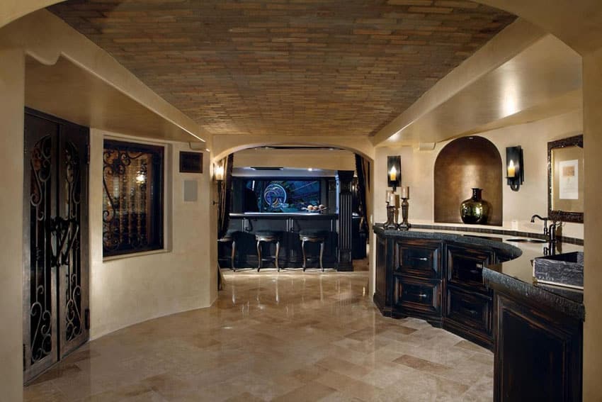 Room with brick ceiling, arched doorway and black stone counters