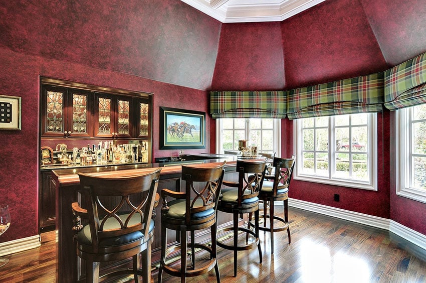 Custom home bar with window views and hardwood floors