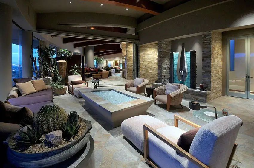 Room with travertine wall cladding and exposed beam ceilings