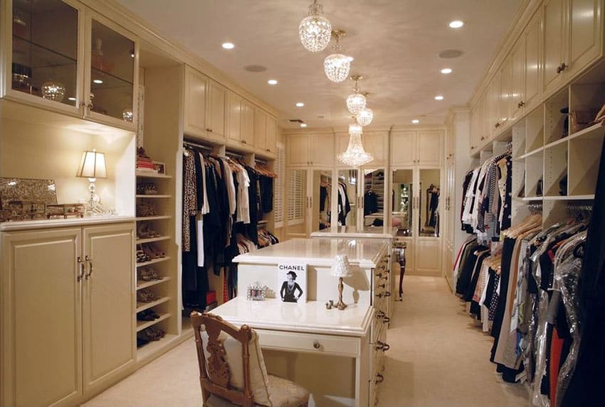 Dream walk in closet with island, mirrors, shoe rack and chandeliers