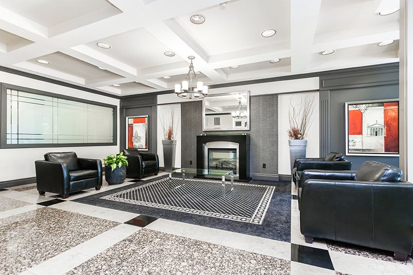 Contemporary living room design with black leather armchairs, modern fireplace and polished granite floors