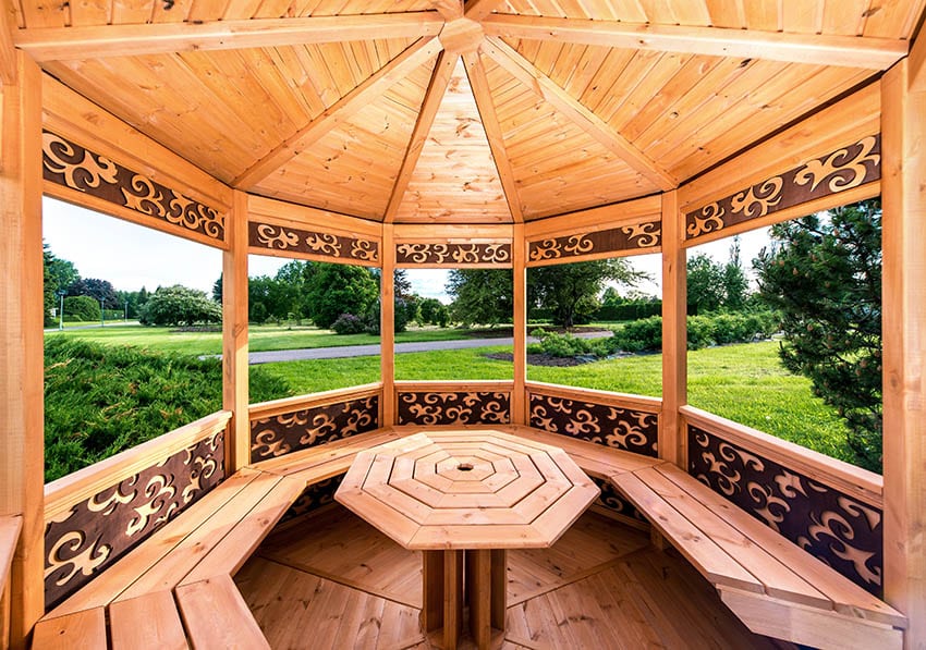Eight sided gazebo with center table with decorative design