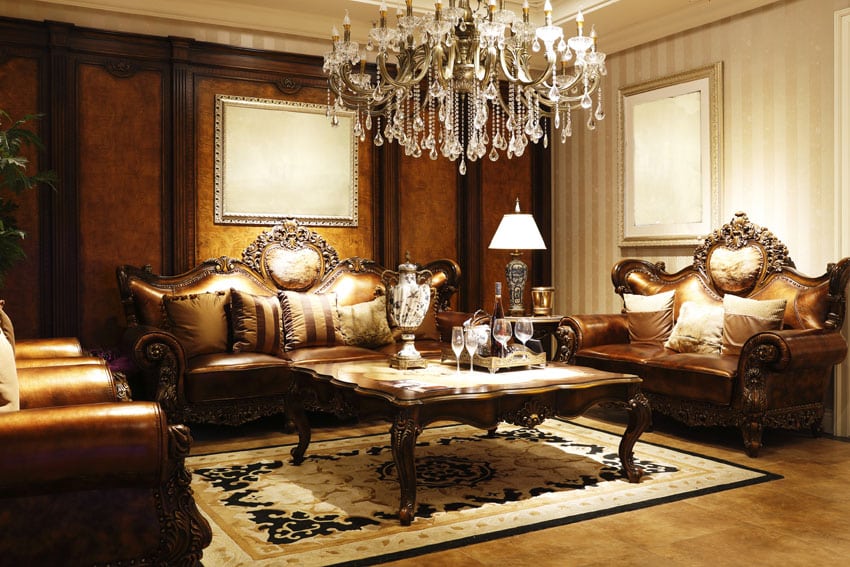 elegant formal living room with leather furniture and chandelier