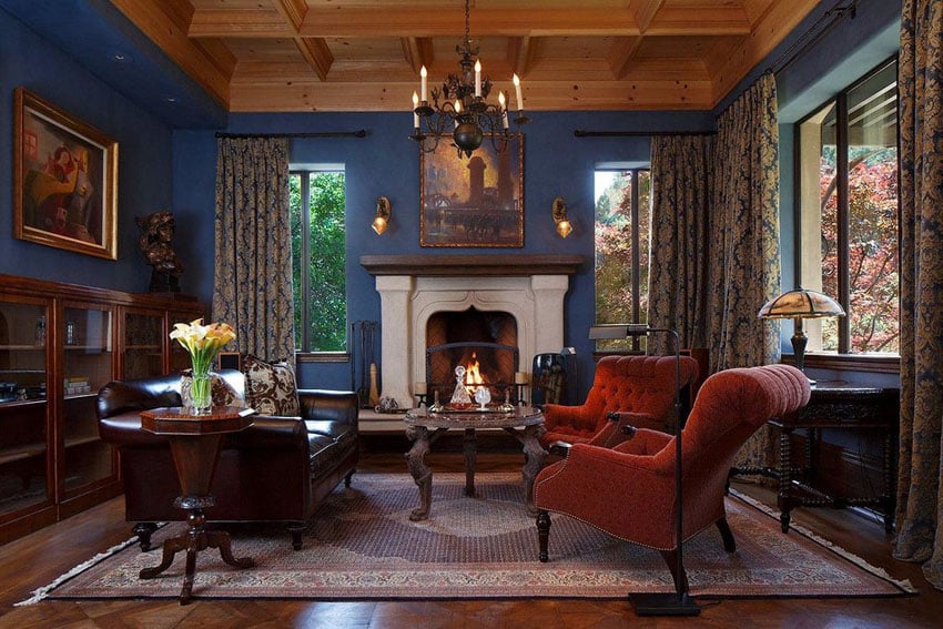 Elegant living room with fireplace and blue walls with wood ceiling