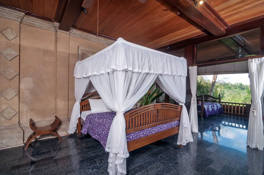 Exotic bedroom with open air layout with balcony and curtained bed
