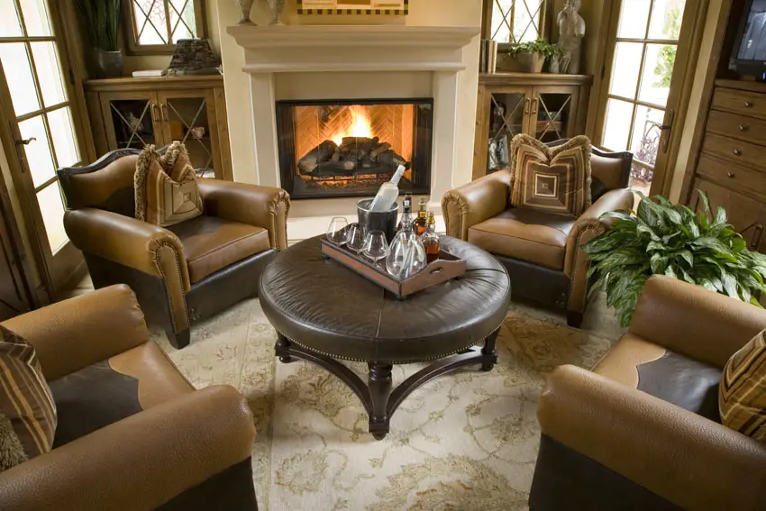 Brown themed room complete with leather couches and textured cushions 