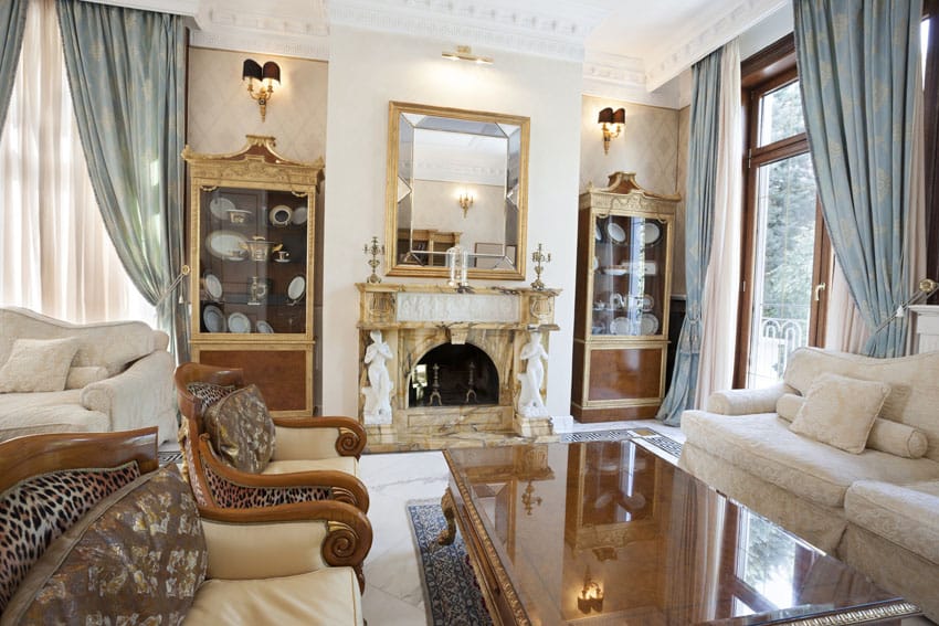 Blue grey curtains, gilded china cabinets and elegant white sofas