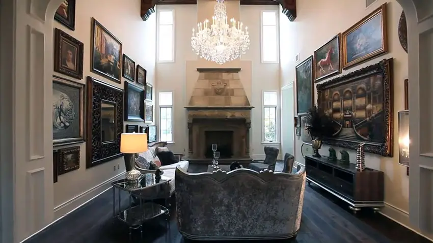 Formal living room with high ceiling chandelier and artwork