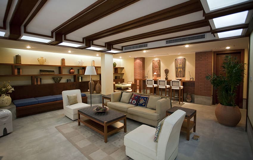 Formal living room with home bar and concrete floors with brick accent walls