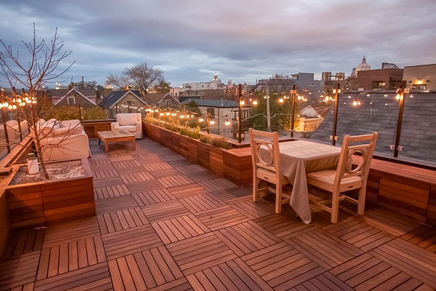 Deck with wood tile in basket weave pattern, outdoor lights and planters