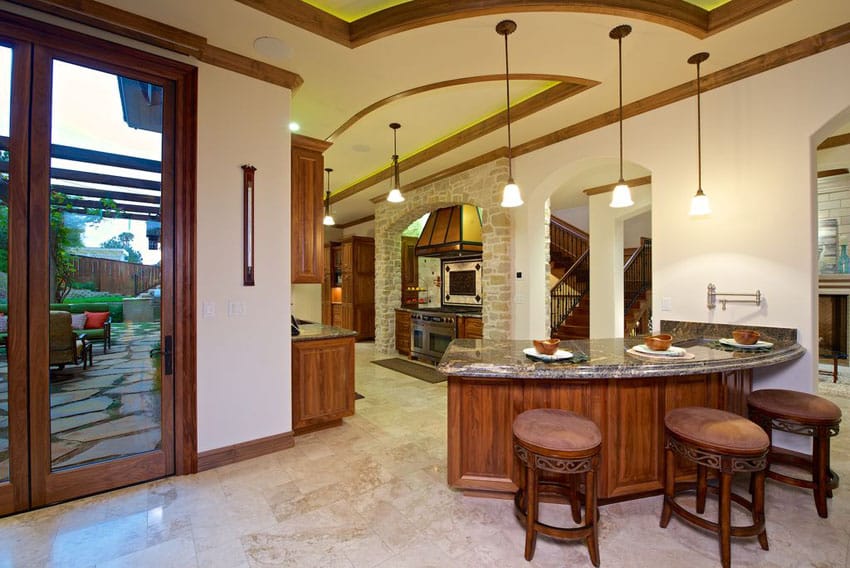 Open plan kitchen with tall door and porcelain flooring