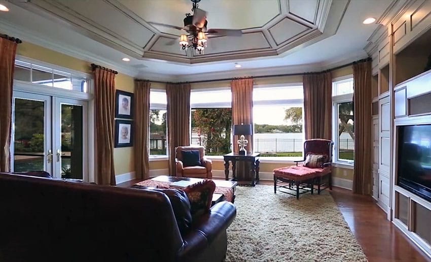 Lake front living room with tray ceiling