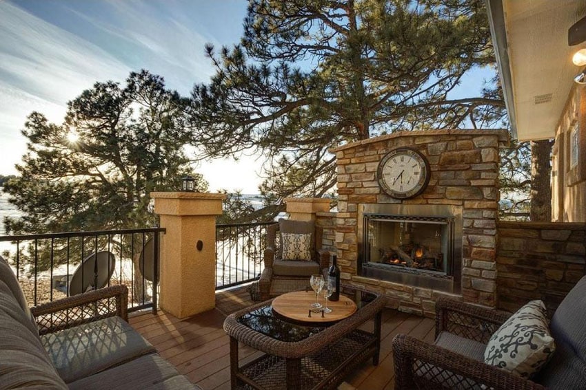 Lake view deck with outdoor stone fireplace