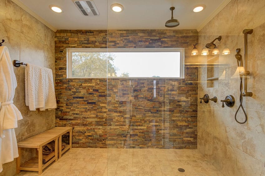 Large contemporary shower with slate and limestone with rainfall shower head