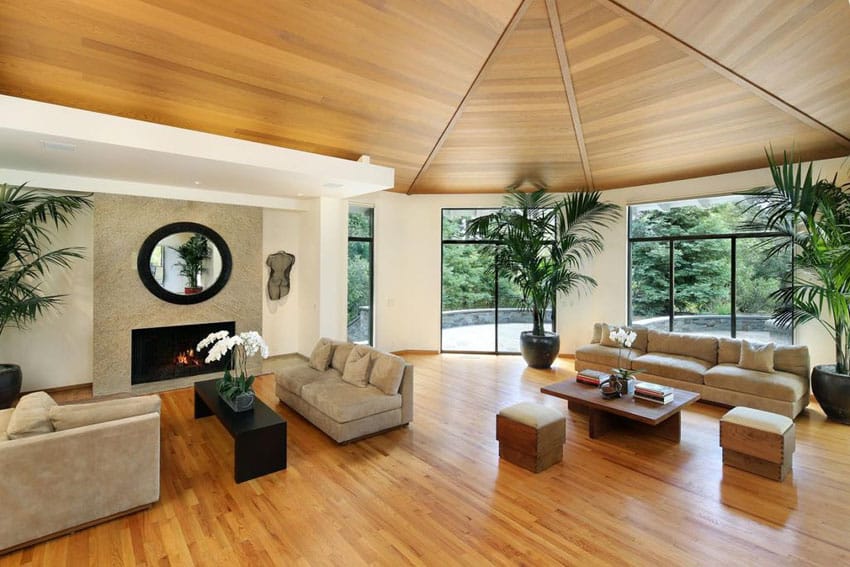 Large living room with hardwood floors wood ceiling and fireplace