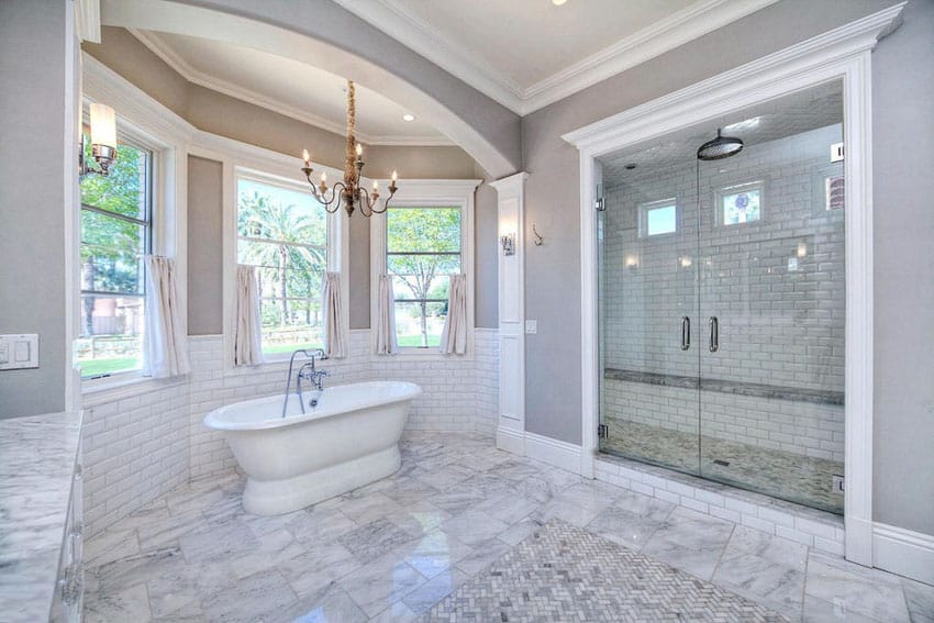 Bathroom with coffered ceiling and three panel windows and bathtub