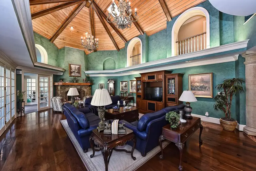 Vaulted ceiling with wrought iron chandeliers and blue furniture