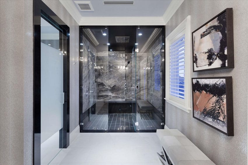 Large shower with gray marble and black tile