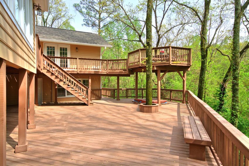 Large two level deck with outlook of surrounding trees