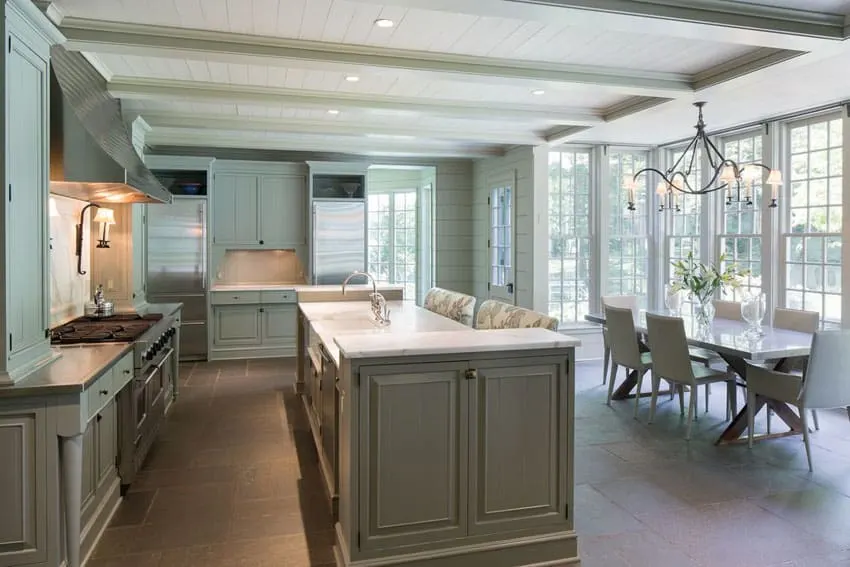 Kitchen with shiplap ceiling, exposed beams and island with raised panel design