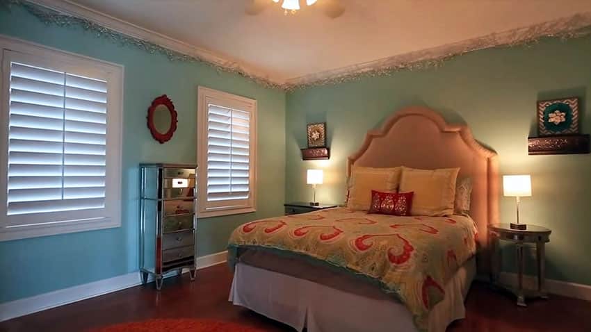 Light blue guest bedroom with plantation shutters