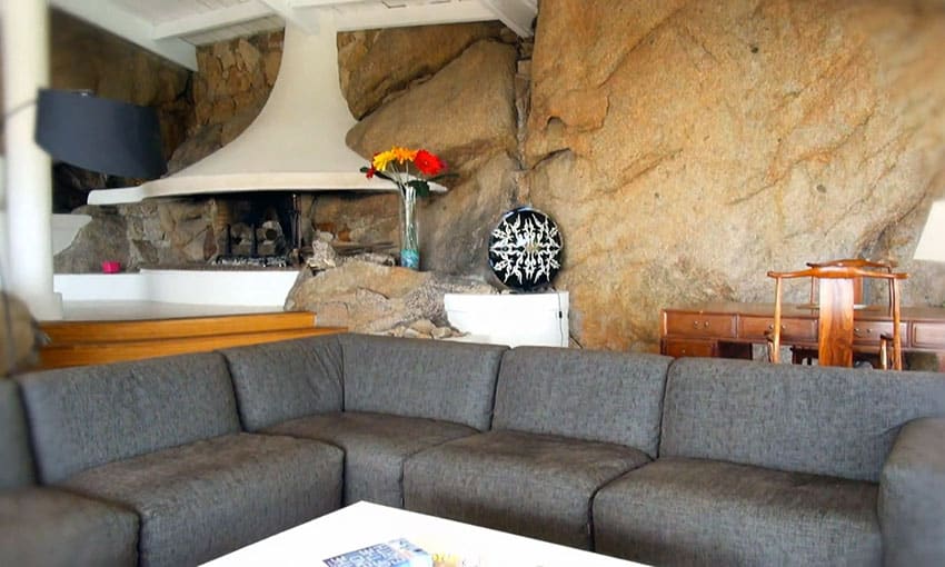Living room with modern fireplace and solid rock wall