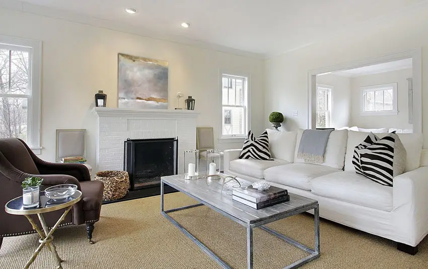 Living room with white sofa and white painted brick fireplace