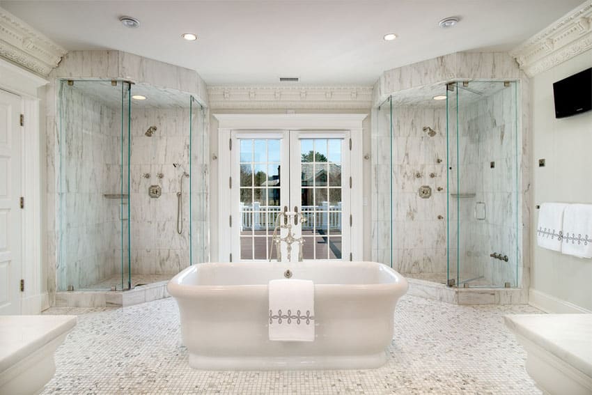 Bathroom with center tub and his and her showers with Carrara marble