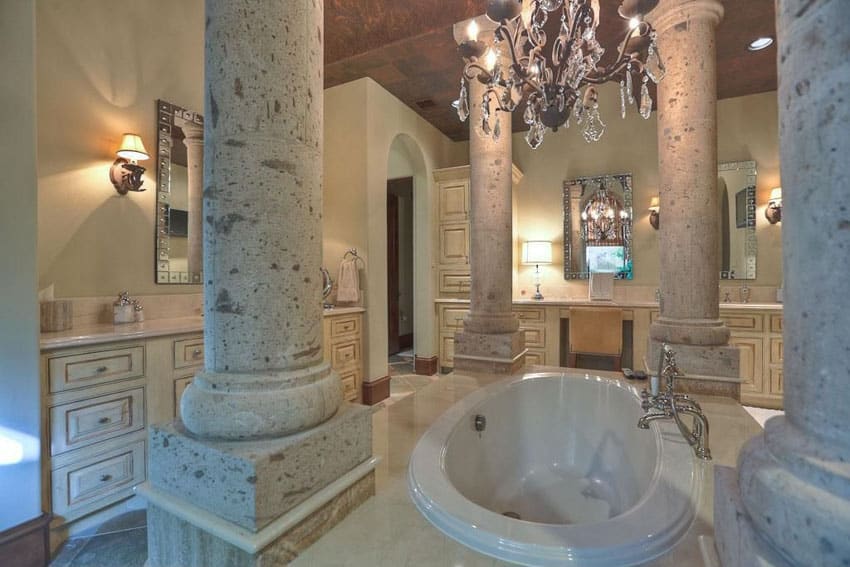 Luxury bathroom with large oval soaking bathtub and chandelier