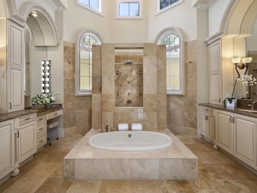 Bathroom with brown granite flooring, adjoining shower spaces and dual vanity counters