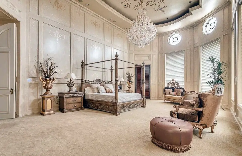 Luxury bedroom with spacious open layout, high ceilings, crystal chandelier and four post bed