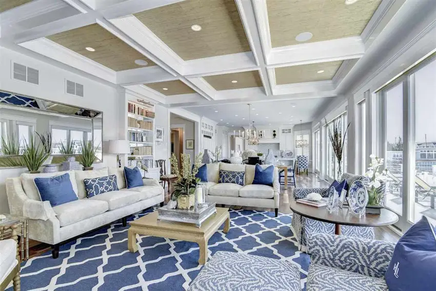 Blue and white themed room with blue rug with geometric patterns