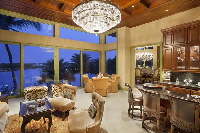Luxury craftsman living room with view of canal and large crystal chandelier