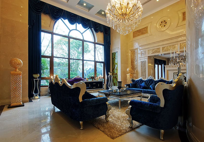Luxury formal living room with dark blue fabric furniture high ceiling with crystal chandelier