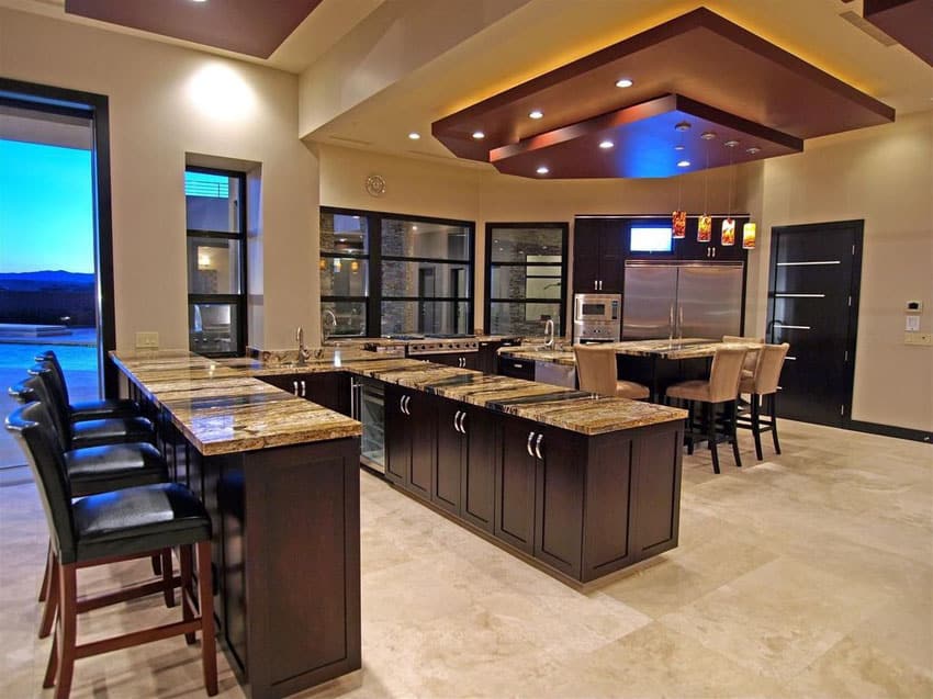 Luxury kitchen with peninsula bar, panel glass window and travertine flooring
