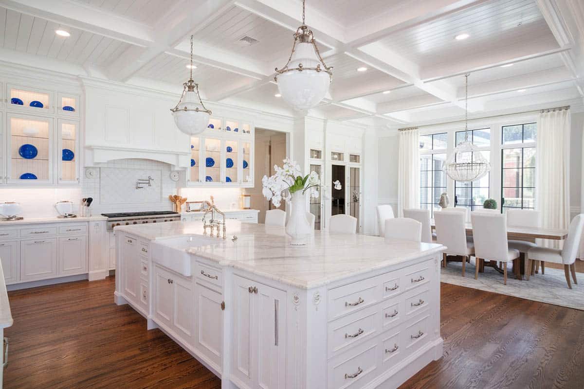Kitchen with french windows, dark wood floors and white cabinets